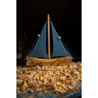 Olive wooden boat with knitted sails blue colour. Olive wooden boat with knitted sails blue colour.